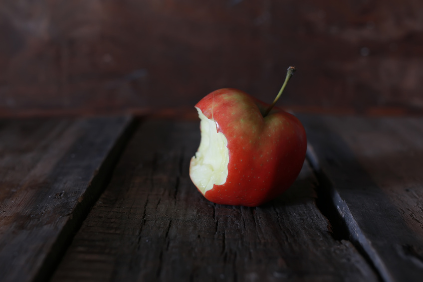 bitten apple on a wooden background